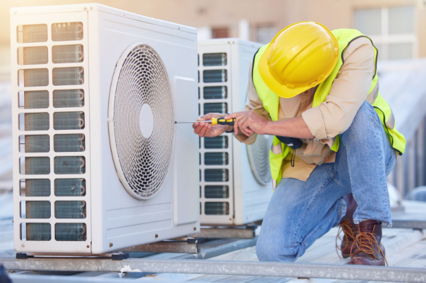 HVAC technician servicing an outdoor air-conditioning unit