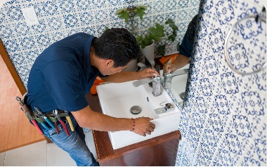 Plumber repairing a sink